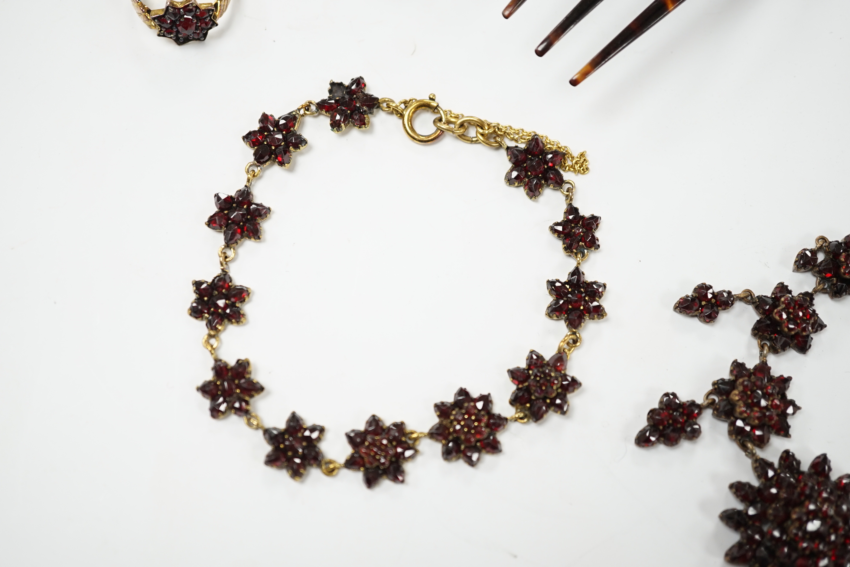 A Victorian garnet set gilt metal and tortoiseshell suite of jewellery comprising bracelet, necklace, ring and two hair combs